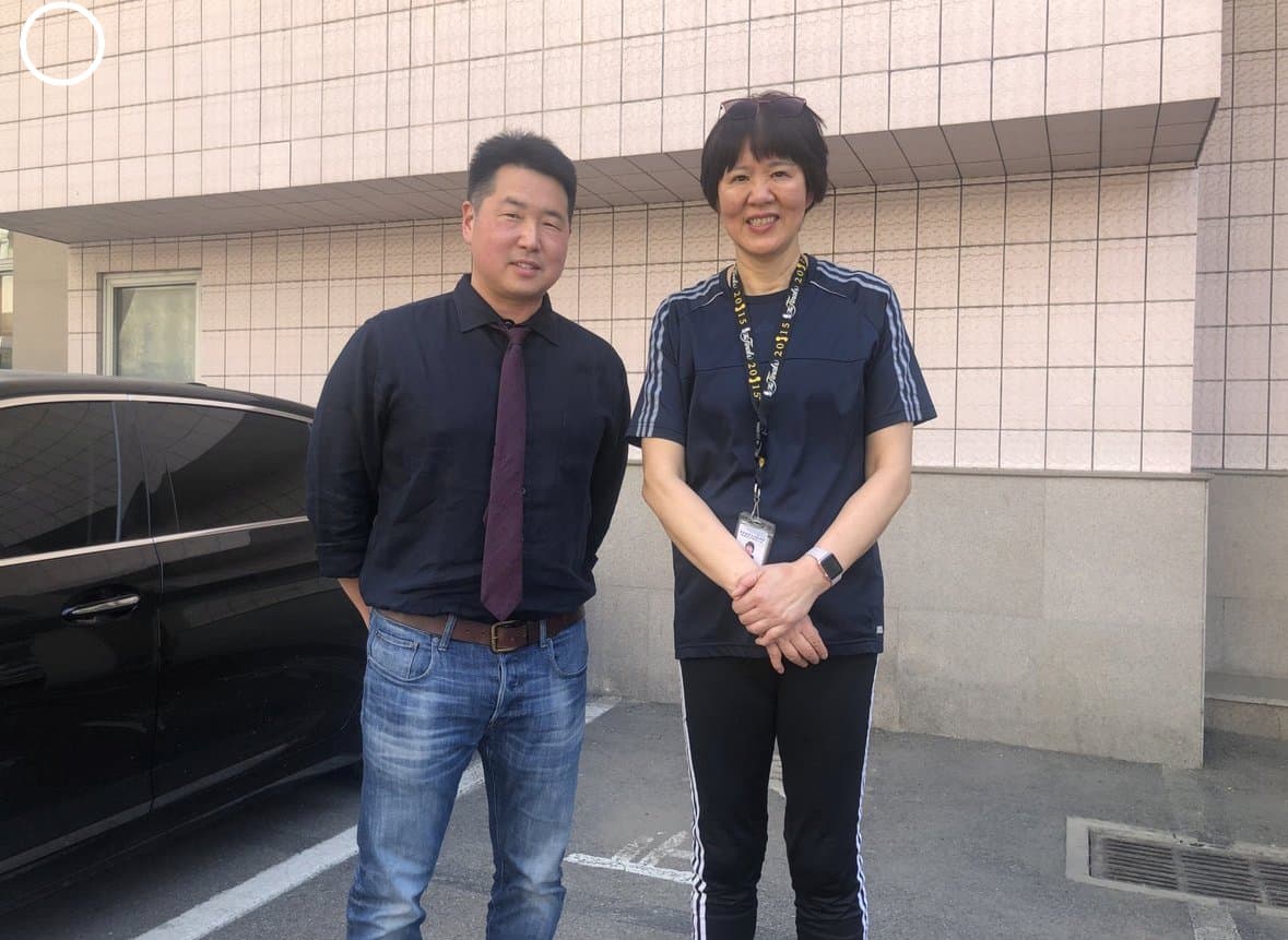 Dr. Koh standing outdoors with a host