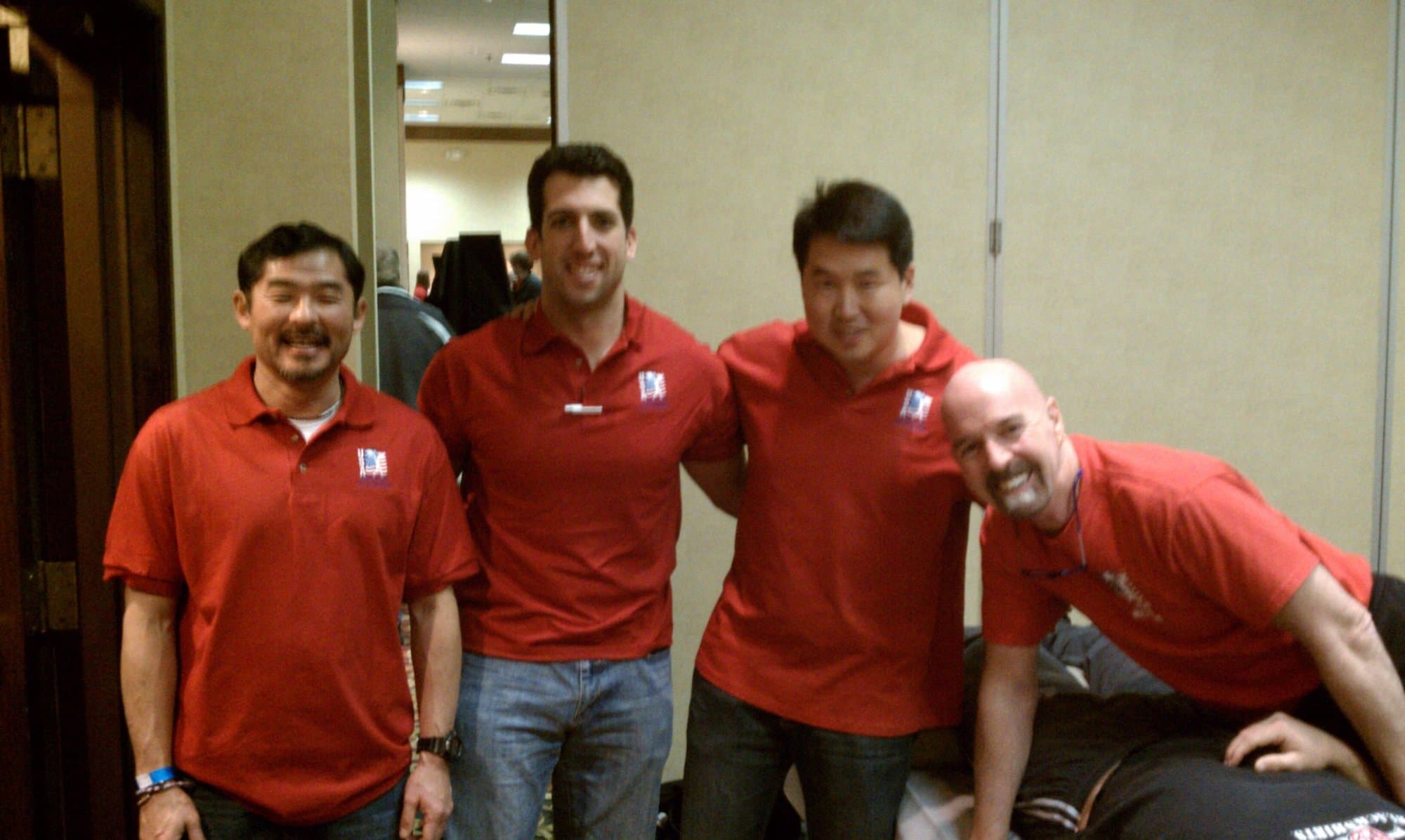 Dr. Koh and three colleagues in matching red polo shirts