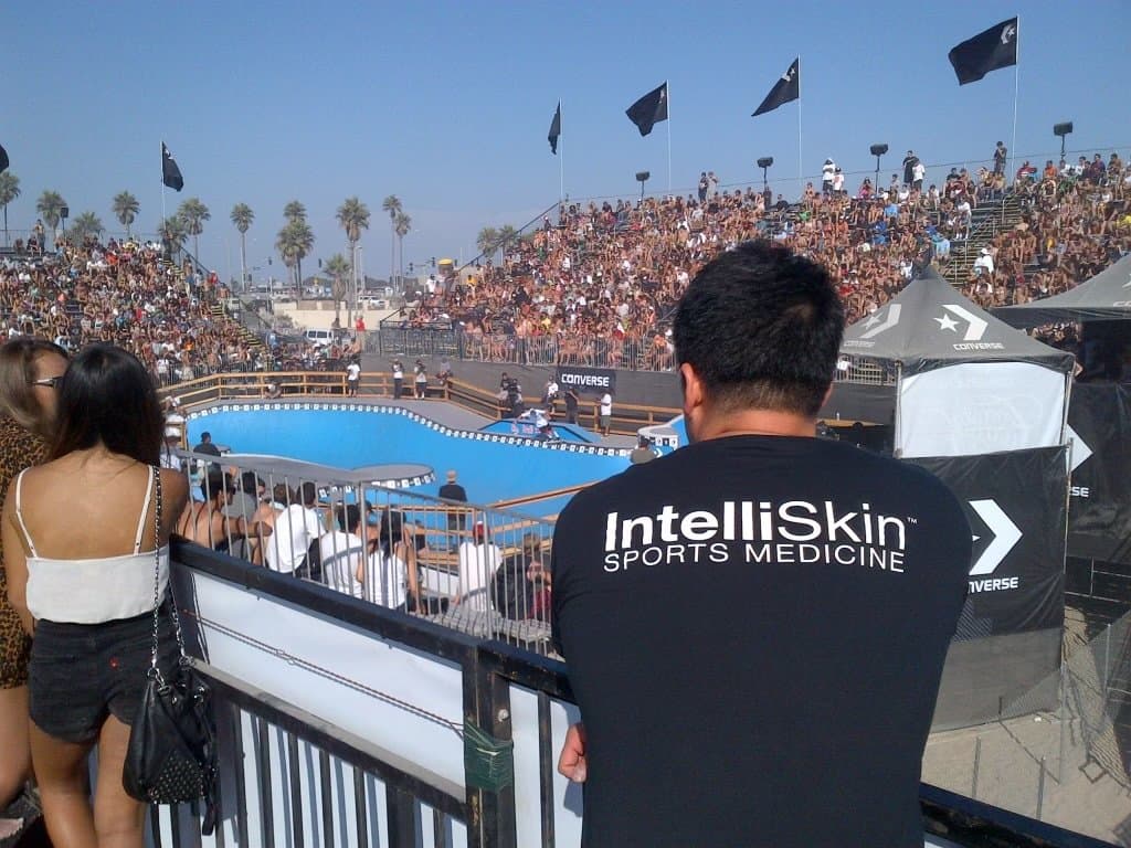 Dr. Koh, seen from behind, looking over a skate bowl and full grandstands at the beach